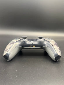 Bottom-edge view of Gray Camouflage PS5 DualSense unit PS5-CMO-002 showing the headset and accessory connections