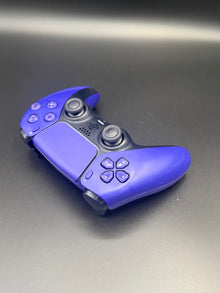 Right-front angled view of Galactic Purple PS5 DualSense unit PS5-GPR-001 showing the face buttons and right grip