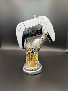 Glacier White PS5 DualSense unit PS5-WHT-HE-001 displayed on a silver robotic hand controller stand