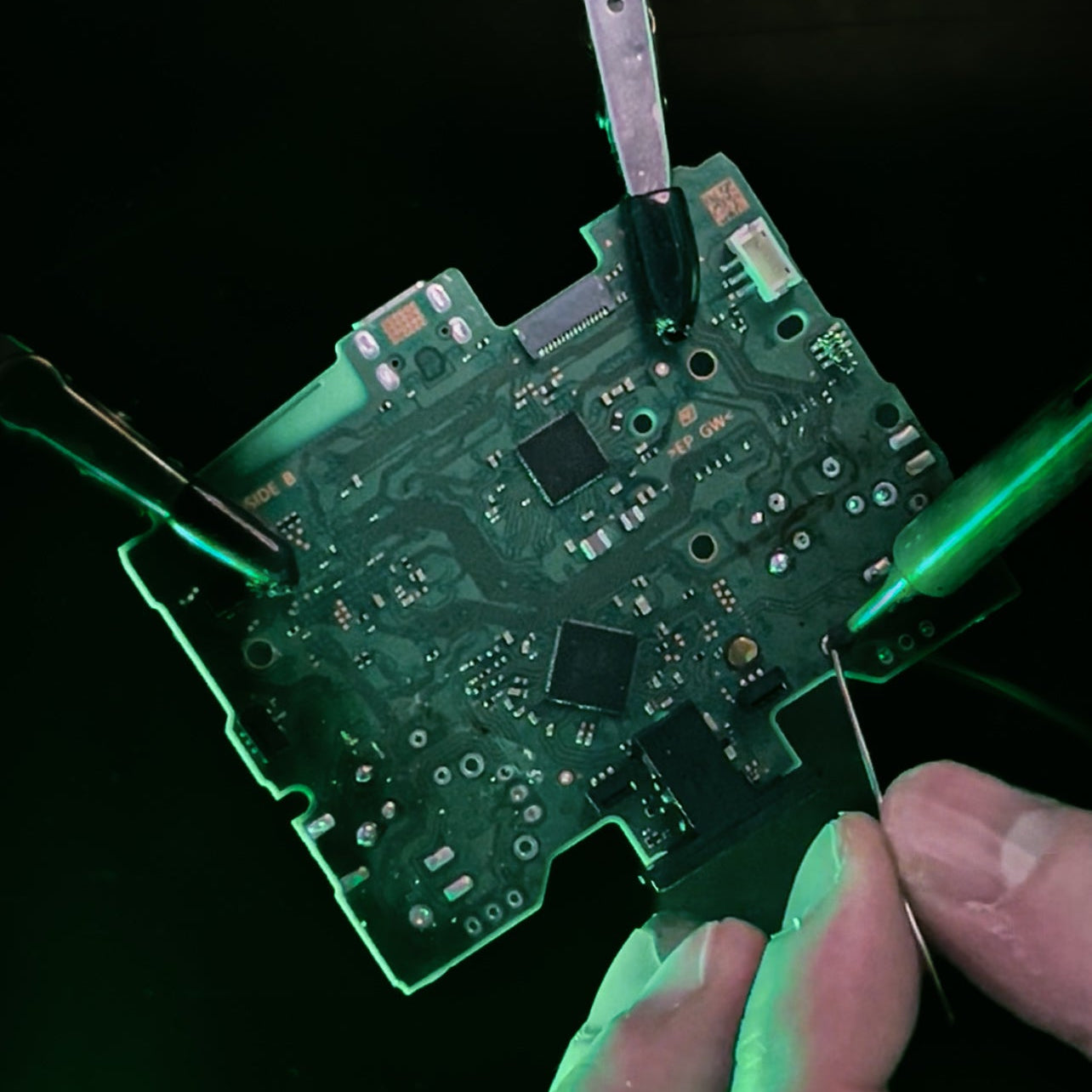 Technician installing a joystick module on a controller circuit board at the TechRevive bench